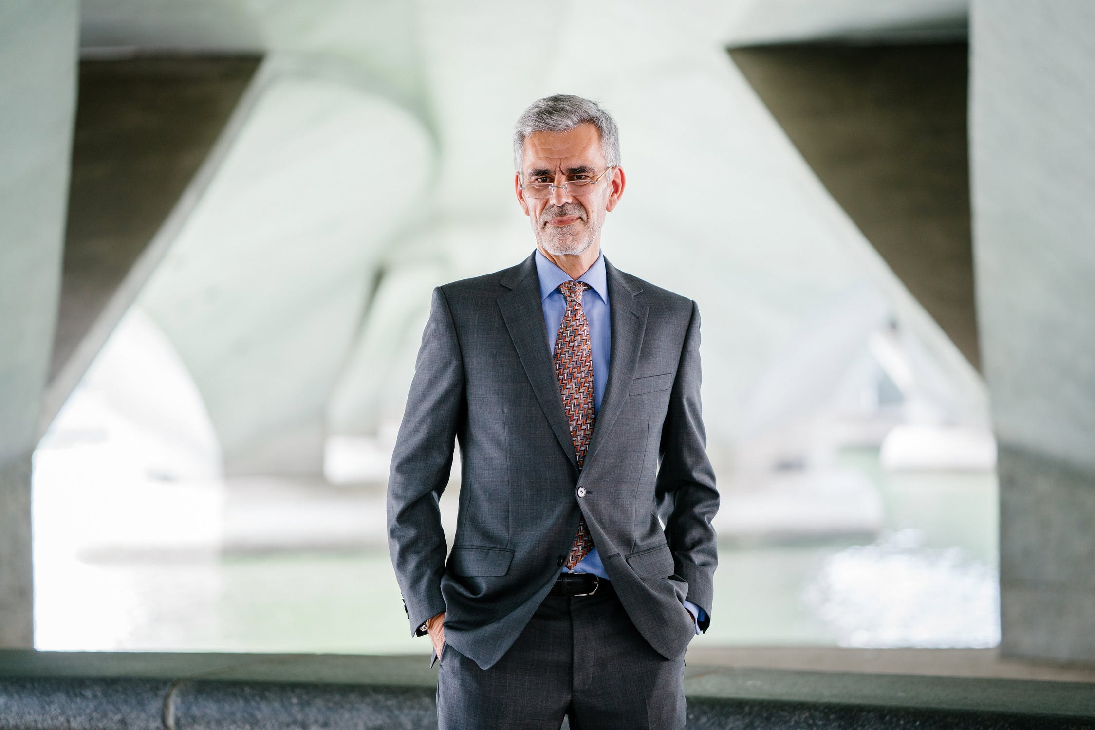 photo business man aged mid fifties in a nice suit with hands in pockets